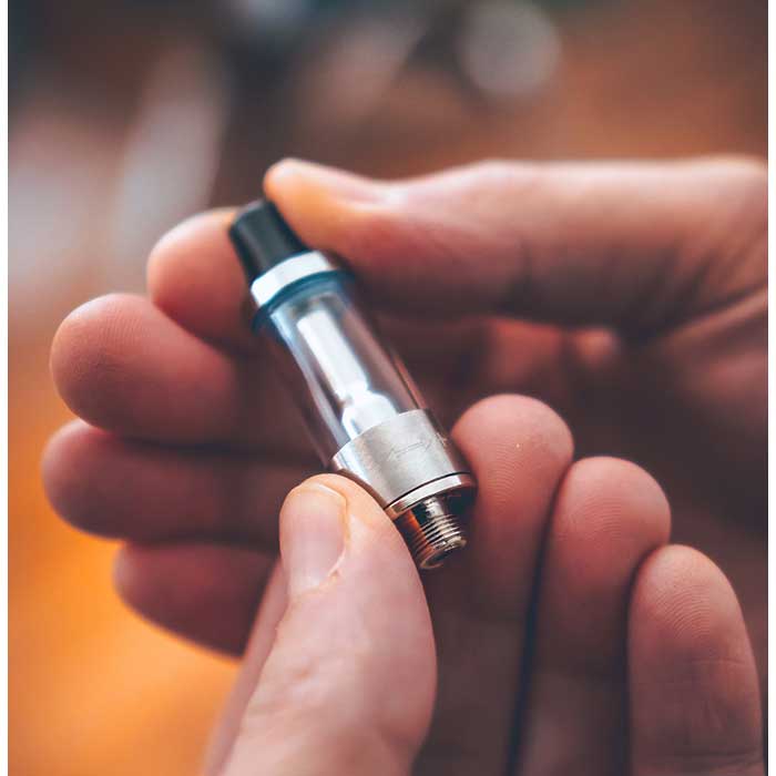 Ispire-Ducore-X-oil-cartridge-lifestyle-photo-in-hand.jpg